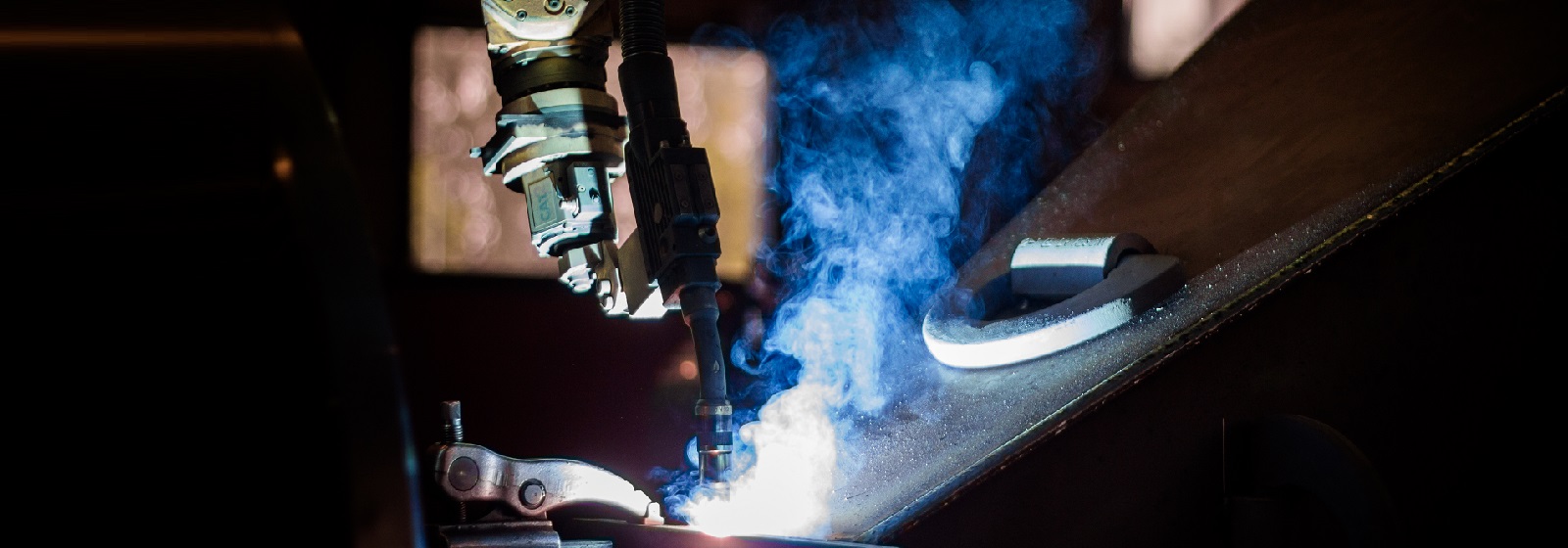 close up of a fanuc welding robot welding